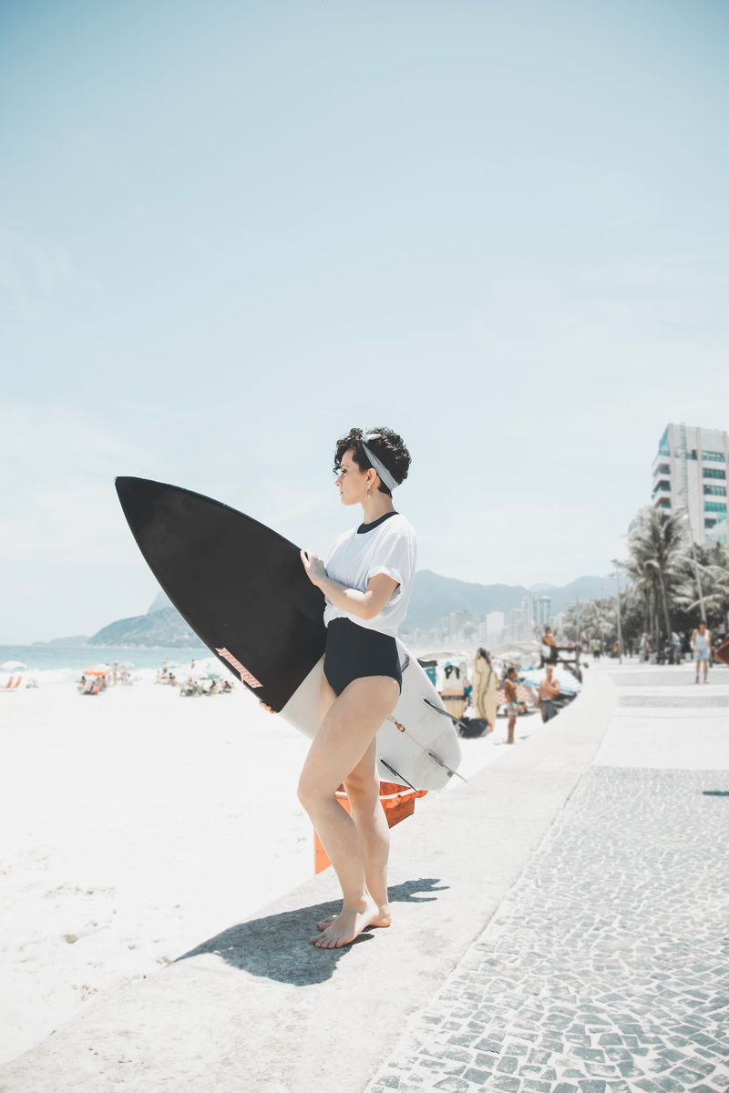 4K, board, land, holding, sky, hairstyle, sunlight, women, full length, day, shirt, surf, focus on foreground, mar, incidental people, one person, riodejaneiro