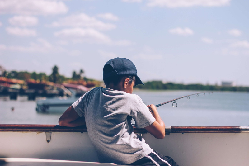 real people, water, transportation system, dock, fishing, boys, fun, river, sport, travel, nature, boy, fish, shore, adolescence, pier, waist up, one person