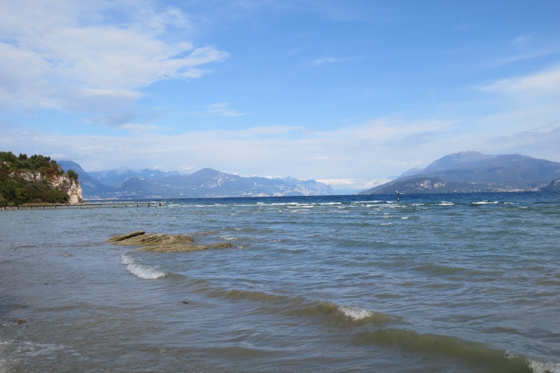 non-urban scene, day, idyllic, beach, no people, wave, sky, garda, beauty in nature, land, mountain range, mountain, tranquil scene, scenics - nature, lake