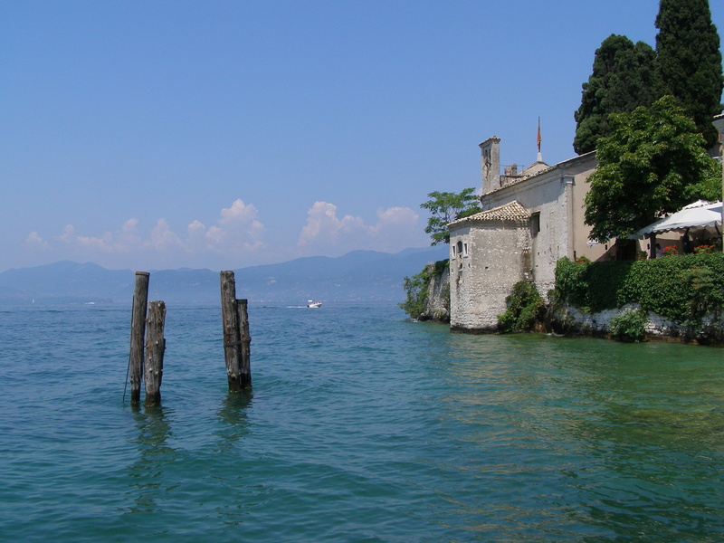 sky, architecture, outdoors, old, building, day, sea, garda, 2K, blue, italy, no people, history, nature, beauty in nature, belief, wooden post, waterfront