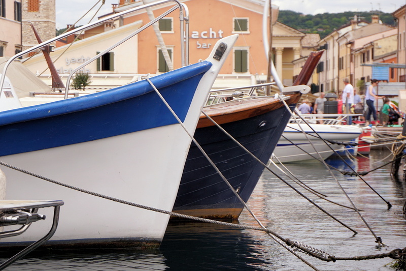 moored, outdoors, garda, port, nautical vessel, incidental people, 4K, wood - material, built structure, anchored, nature, sea, boats, building exterior