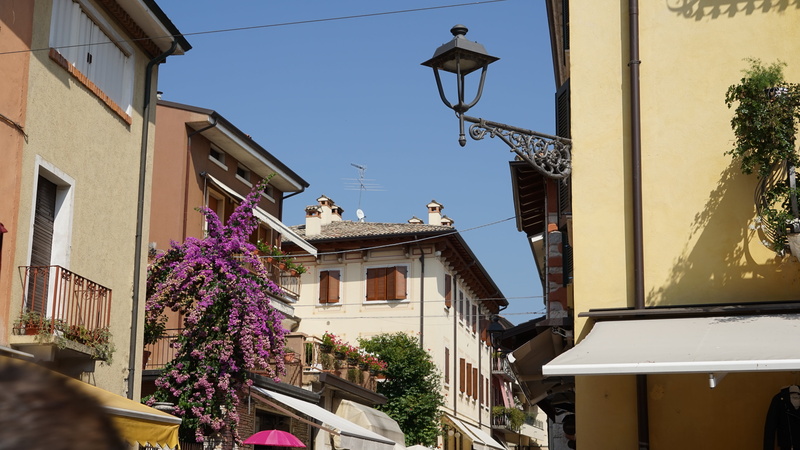 street, building exterior, sky, garda, nature, sunlight, purple, building, italy, window, outdoors, low angle view, residential district, bardolino, built structure
