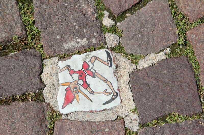 solid, art and craft, stone material, creativity, road, nature, paving stone, high angle view, outdoors, directly above, footpath, human representation