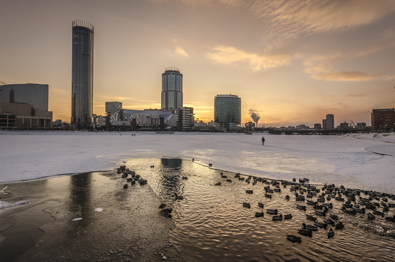 sunset, no people, building exterior, city by the sea, body, frozen, city life, urban skyline, lake, sky, cityscape, water, built structure, sea, beach
