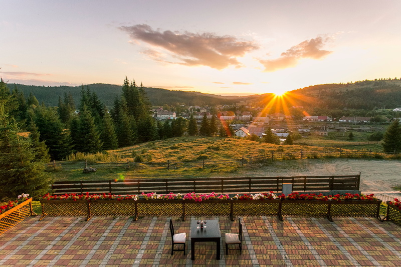 high angle view, building exterior, golden, sunrise, chairs, chair, beside, orange color, bench, flower, highland, cloud, beauty in nature, grass, two