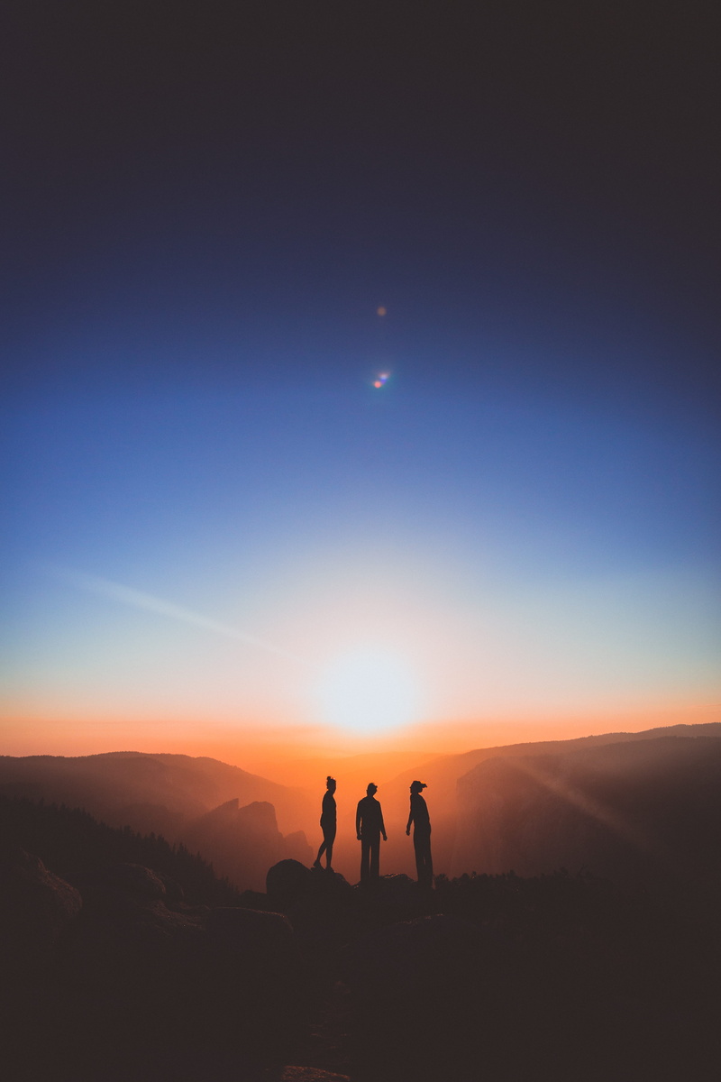 leisure activity, smoke, confidence, nature, sun glare, summit, non-urban scene, lifestyles, sky, fire, mountain, sunset, tranquil scene, people, silhouette