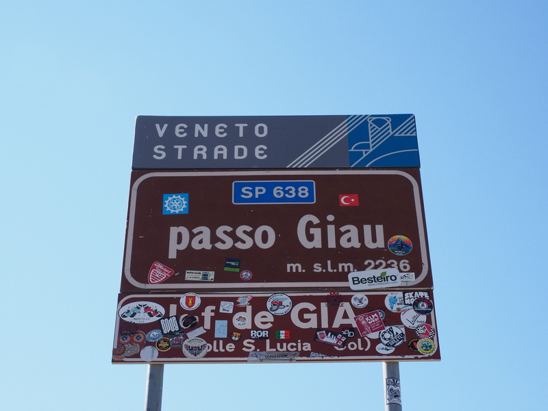 blue, traffic sign, dolomites, clear sky, no people, sunny, pass shield, blue background, communication, road, guidance, transportation, giau pass, capital letter