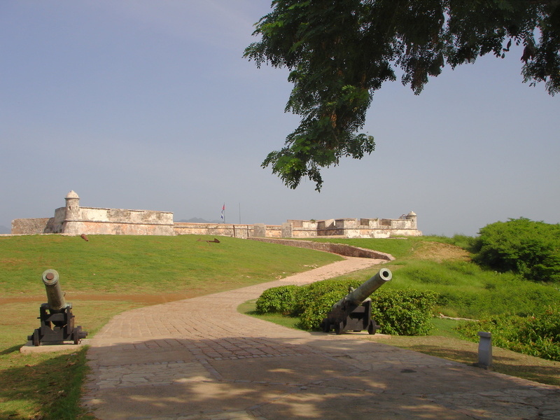 no people, castle, clear sky, sunlight, outdoors, history, el castillo del morro, nature, direction, the past, fort, guns, grass, built structure, famous Place