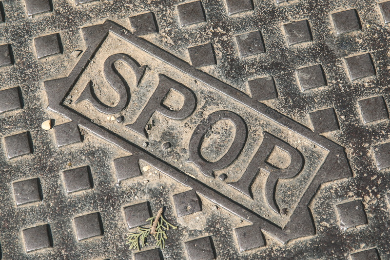 street, full frame, close-up, text, capital letter, communication, no people, wall - building feature, sign, western script, high angle view, manhole, concrete