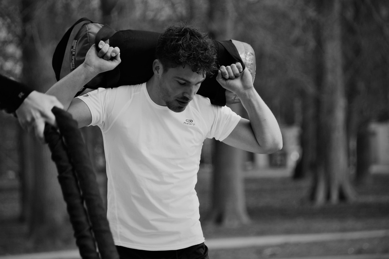 black and white, male, sport, duffel, photography, holding, work, sweat, outdoors, lifestyles, determination, focus on foreground, young men, activity