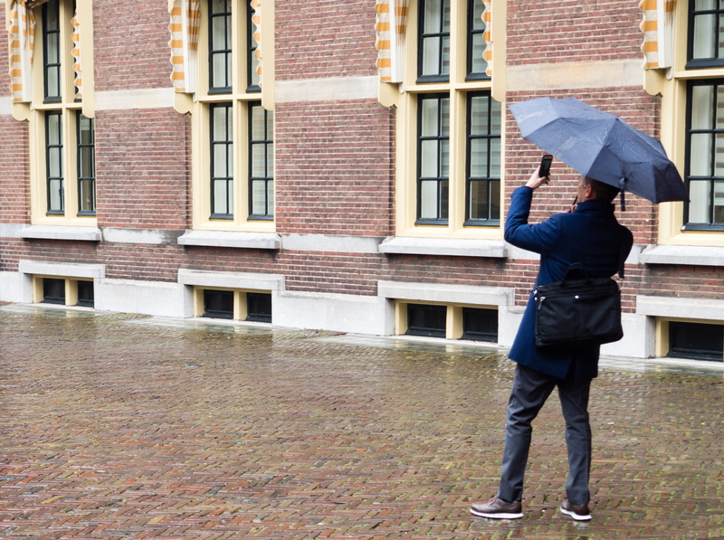 protection, holding, rain, building exterior, full length, umbrella, building, the hague, outdoors, tourist, water, standing, architecture, rainy season
