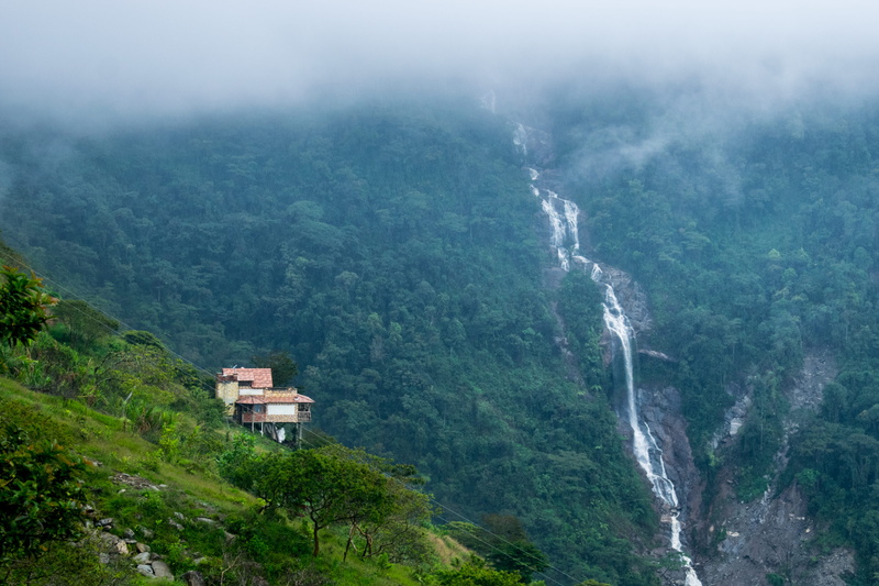 mountain peak, architecture, power in nature, fog, tree, mountain, environment, waterfall, landscape, high angle view, beauty in nature, valley, colombia