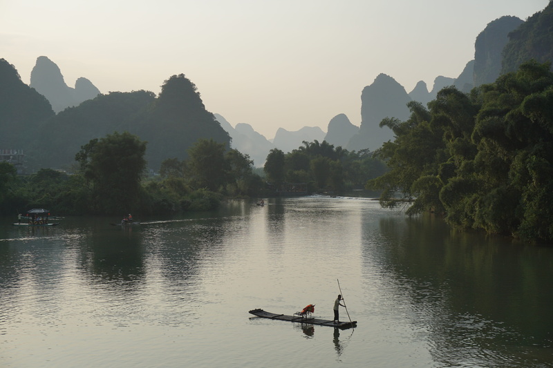 yulong river, people, scenics - nature, beauty in nature, mountain, sky, lifestyles, plant, non-urban scene, mountain range, bamboo raft, nautical vessel
