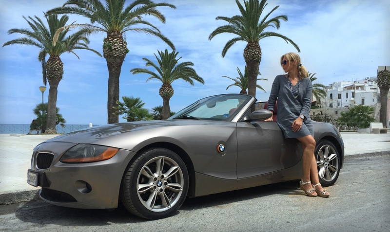 land Vehicle, bmw, gray, convertible, coupe, sky, tropical, outdoors, sports Car, leisure activity, woman, seaside, sleeved, dress, plant, adult, vehicle