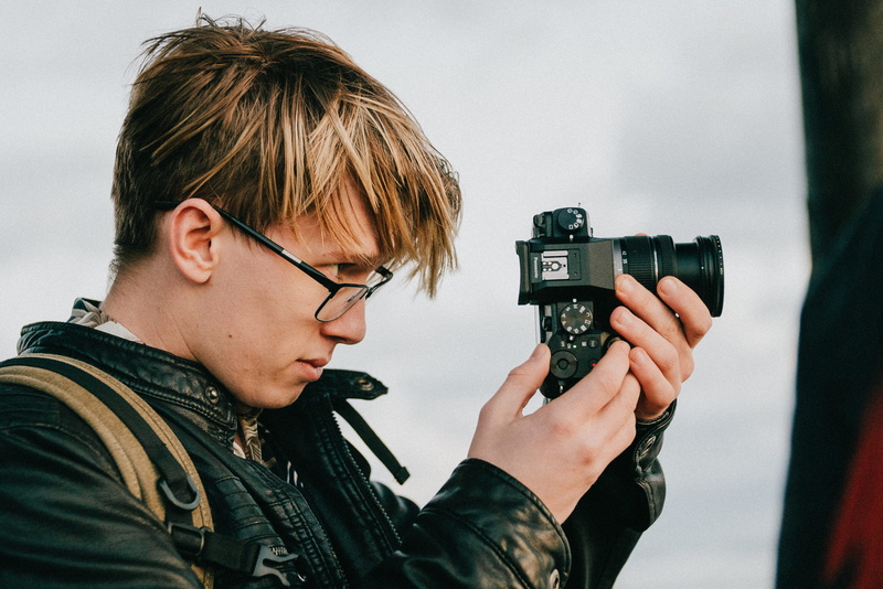 gun, holding, camera lens, men, 4K, accessory, person, portrait, human, headshot, knitting, eyeglasses, digital camera, finger, photography, accessories