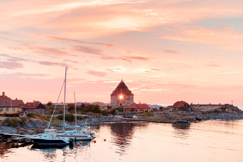 river, dock, sunset, watercrafts, waterfront, sailboat, pier, oceanshore, spire, outdoors, rocky shore, sky, clouds, bay, harbor, seashore, building, cloud - sky