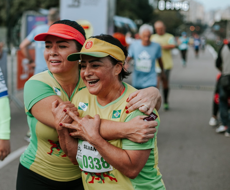 females, leisure activity, real people, standing, outdoors, focus on foreground, positive emotion, fitness, running, athletes, action, green, road, wear
