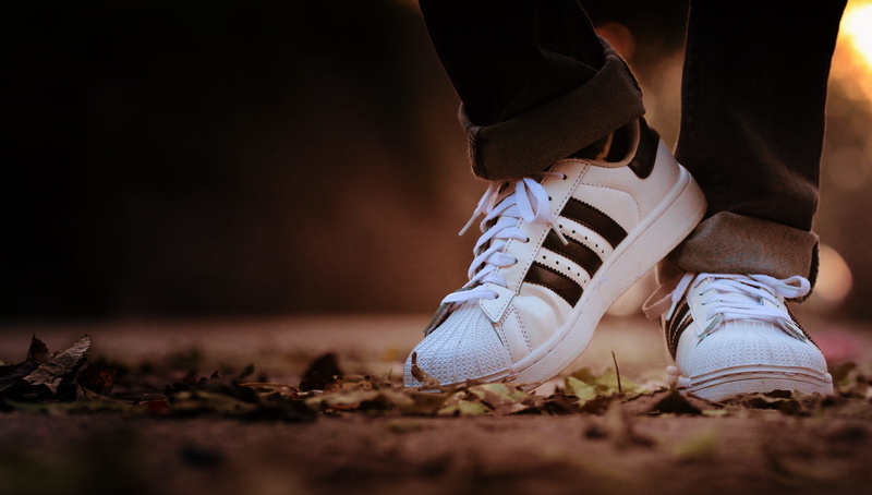 selective focus, sneakers, black, body part, white, standing, human limb, low section, sport, shoes, adult, shoe, human leg, pair, trainers, surface level