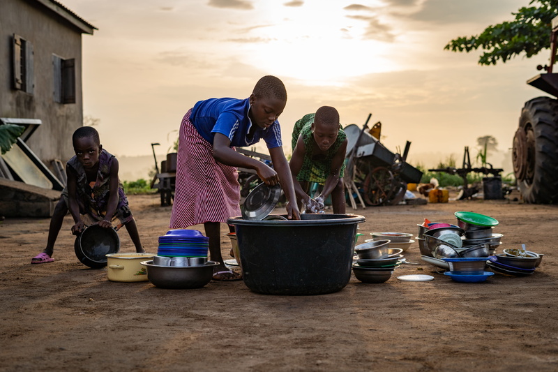bending, people, day, dishes, poor, full length, males, african, children, young men, mature adult, cleaning, sky, young adult, togo, casual clothing, child