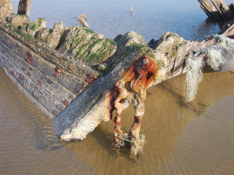 outdoors, boat sunk in 1930, no people, wreck, beach, wood, solid, tranquility, sea, high angle view, transport of salt, ruined, driftwood, sunlight, storm