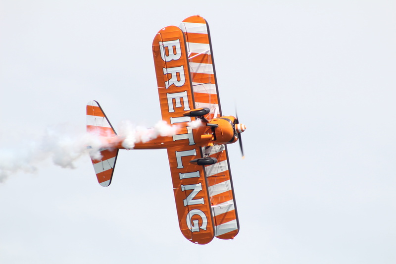 day, adult, airplane, air show, airshow, low angle view, one person, orange color, arts culture and entertainment, Planes, air vehicle, rescue worker, nature