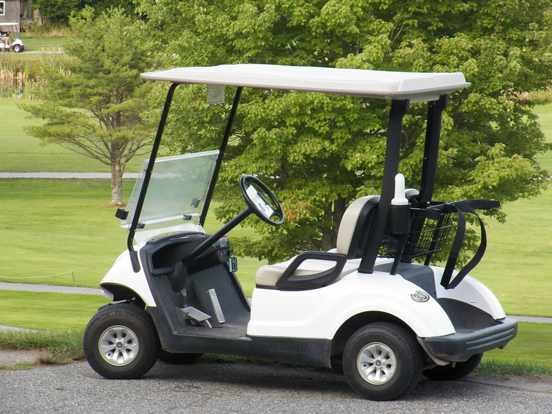 outdoors, no people, nature, field, grass, white, cart, stationary, gray, black, golf club, green color, sport, golf cart, land vehicle, sports, sunlight