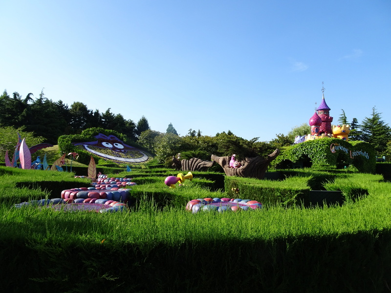 built structure, day, beauty in nature, country of the wonders, group of people, clear sky, garden, field, outdoors, disneyland, sky, building exterior
