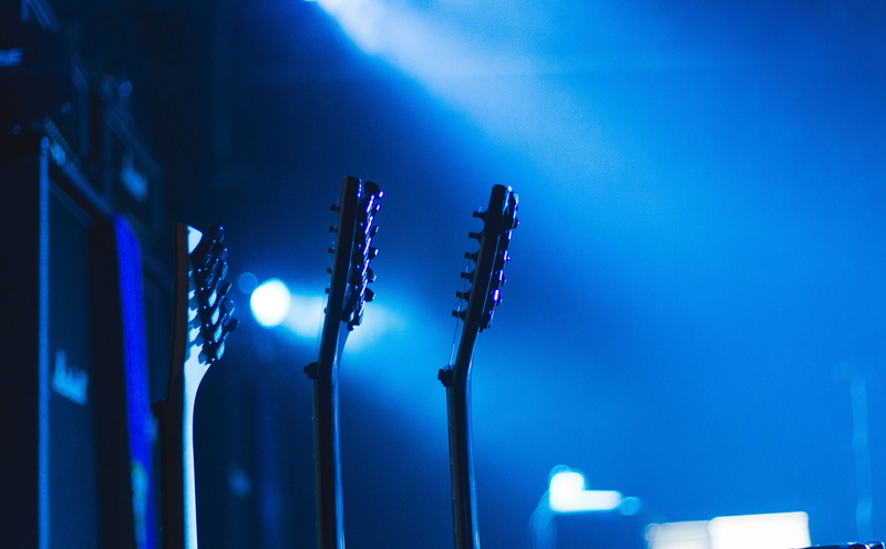 nightlife, guitar, headstocks, electric lamp, glowing, light, arts culture and entertainment, night, close-up, performing arts event, indoors, three, light - natural phenomenon