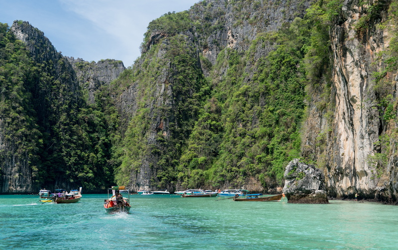 colorful boats, destination, rock - object, solid, sky, water, outdoors, seascape, vacations, waterfront, land, beauty in nature, mountain, nautical Vessel