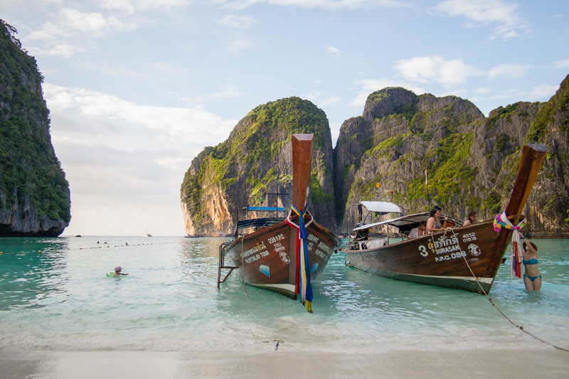 holiday, tranquility, nautical vessel, scenics - nature, tranquil scene, near, water, formation, outdoors, the beach, koh phi phi, boat, cloud - sky, beautiful beaches