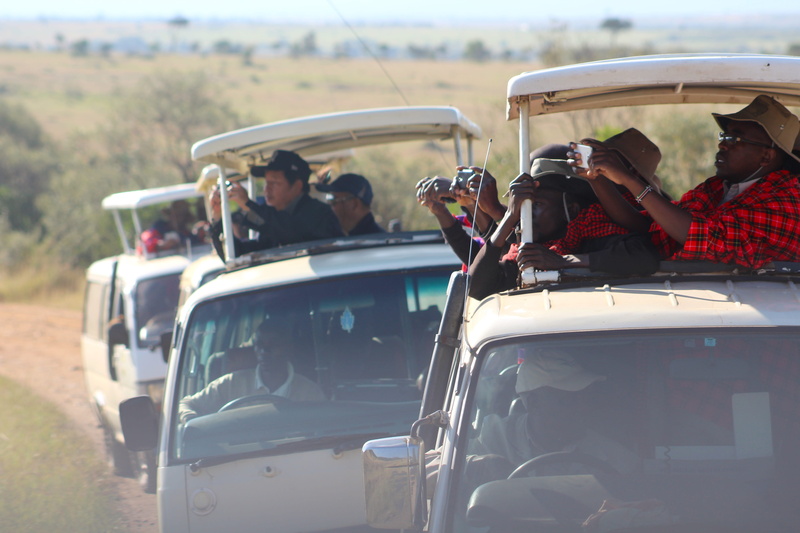 nature, automobile, group of people, helmet, outdoors, adult, person, clothing, driving, land vehicle, riding, road, mirror, mode of transportation, photo