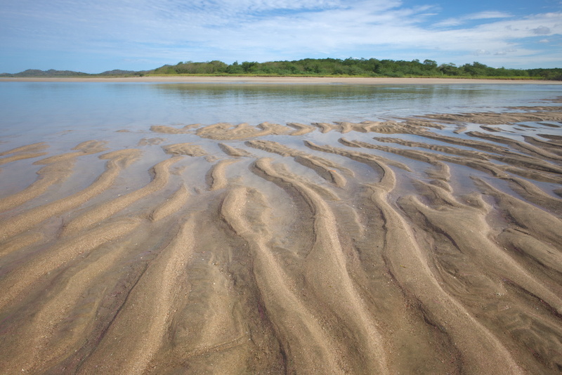 tranquil scene, tamarindo, no people, non-urban scene, patterns, lake, water, pattern, wave pattern, idyllic, beauty in nature, sand, tranquility, land