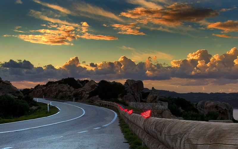 sign, transportation, windows, street, curve, environment, gray, the way forward, direction, streets, beauty in nature, sunset, sky, scenics - nature