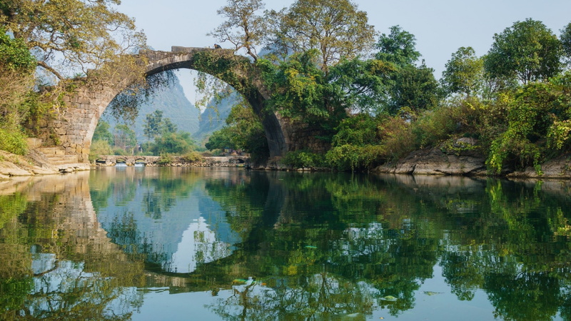 tree, nature reserve, plant, guangxi, vegetation, china, yangshuo, arch bridge, bank, sky, lake, yulong river, outdoors, tranquility, waterway, yulong bridge