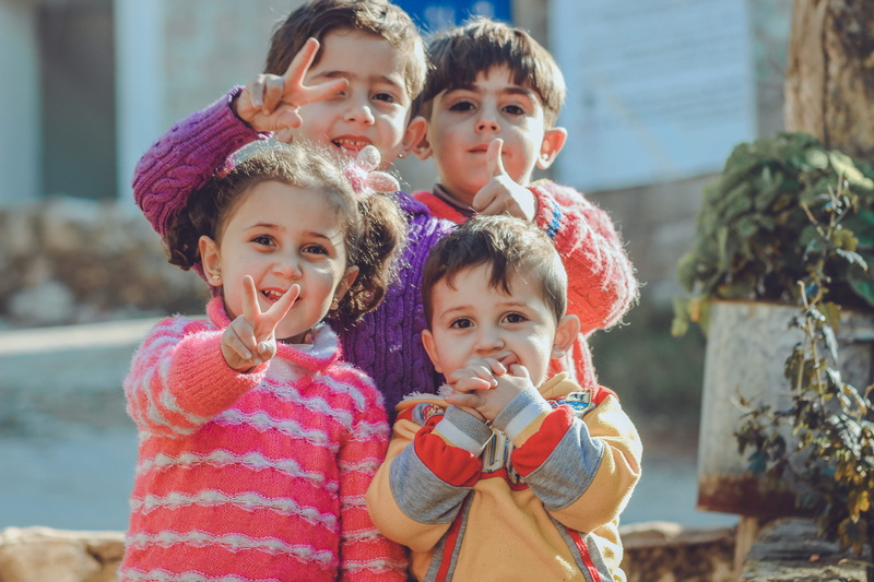 enjoyment, outdoors, adorable, cute, females, positive emotion, looking at camera, males, smile, sibling, boy, leisure, young, family, women, girls, child