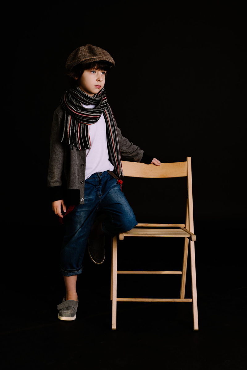 pose, black background, seat, wear, men, lifestyles, adolescent, standing, contemplation, males, child, dark, young, facial expression, childhood, pre-adolescent child