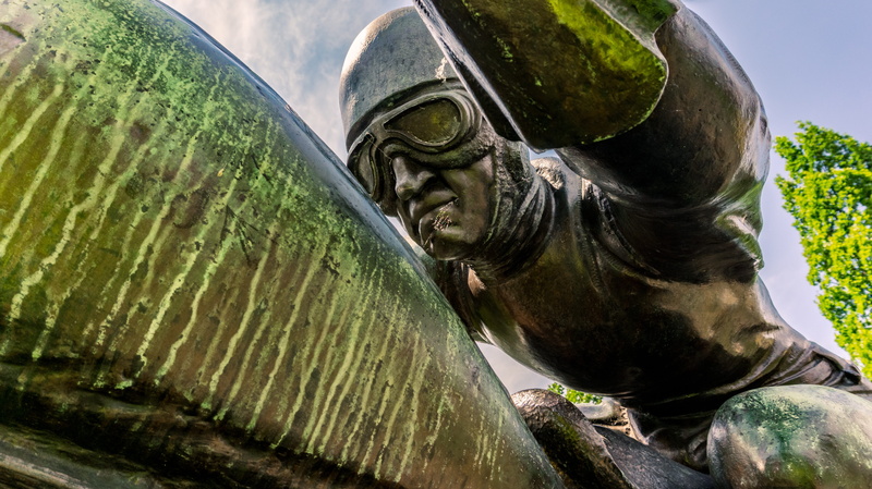 human representation, green color, aviator, monument, helmet, face, craft, old, 5K, goggles, plant, motorcycle, half, statue, nature, wearing, no people