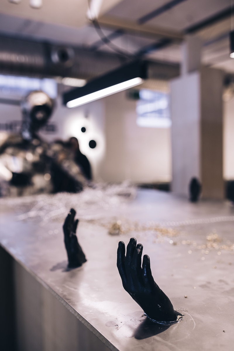 figures, still life, low section, focus on foreground, close-up, people, sculpture, built structure, illuminated, exposition, shoe, installation, arts culture and entertainment