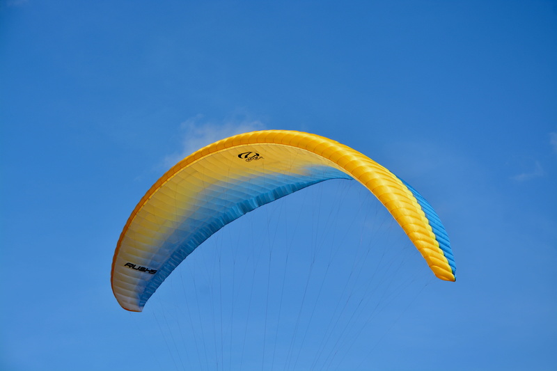 nature, paraglider wing, leisure, flight, blue background, sky, blue, parachute, wing ozone rush 5, air aircraft, single object, adventure, yellow, extreme sports