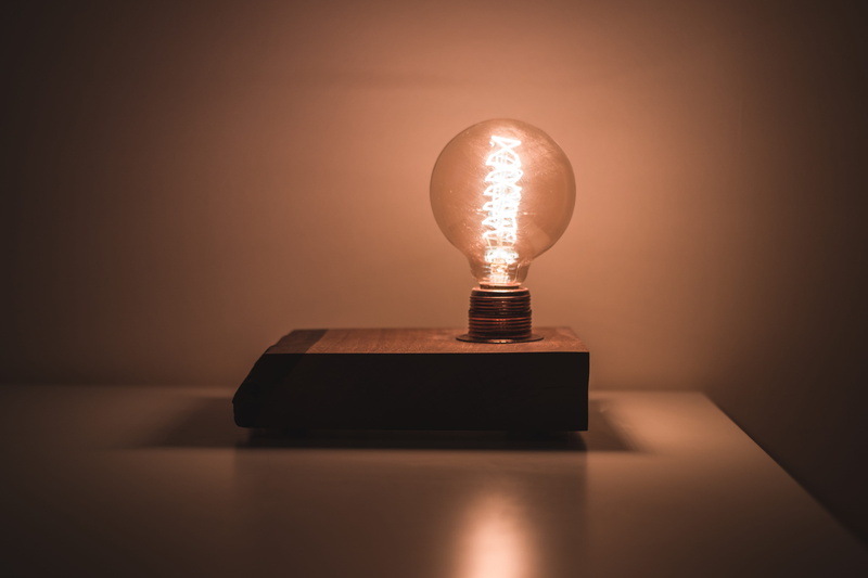 white, single object, room, art, wall - building feature, indoors, design, light bulb, light, electric lamp, energy, surface level, table, lighting equipment