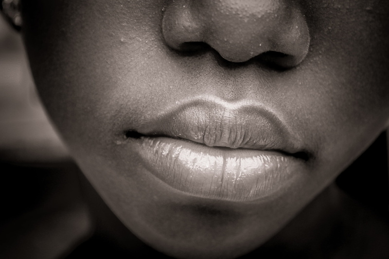woman, africa, young adult, baby, giraffe, sleep, black background, girl, human mouth, human lips, adult, small child, color, lips, black skin, black, portrait