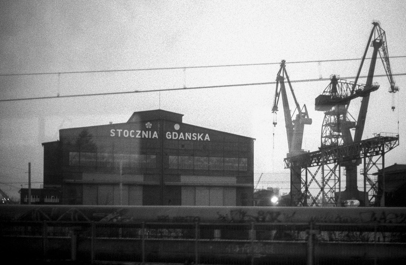 text, building exterior, film, gtn, railing, outdoors, machinery, communication, electro, yashica, script, architecture, transportation, crane - construction machinery