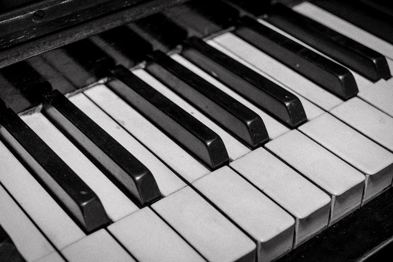 play, leisure activities, no people, high angle view, music, indoors, monochrome, antique, white color, pattern, musician, white, black color, old, piano