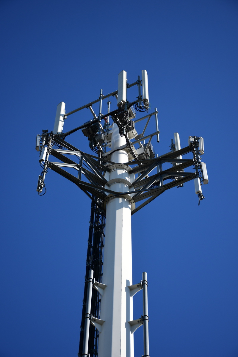 low angle view, wire, radio, tall - high, clear sky, sunlight, no people, blue, architecture, steel, cellular tower, metal, transmitter, antenna, directly below