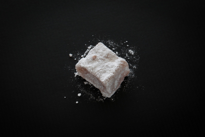 loukoumi, dark, salt - seasoning, black color, studio shot, sugar cube, sugar, white, sweet, exploding, copy space, single object, close-up, eat, destruction