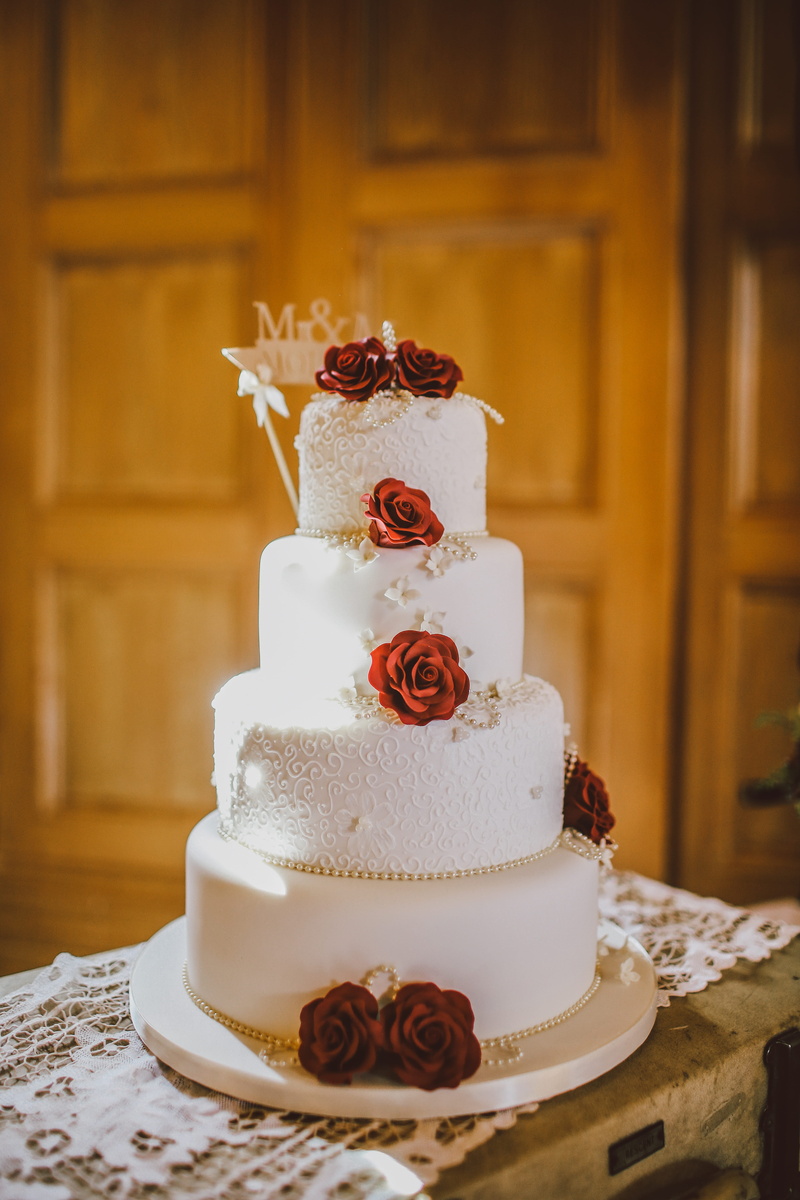 focus on foreground, red, christmas cake, food and drink, celebration, floral, tiered, tier, flower, still life, cake, wedding cake, dessert, layered, freshness