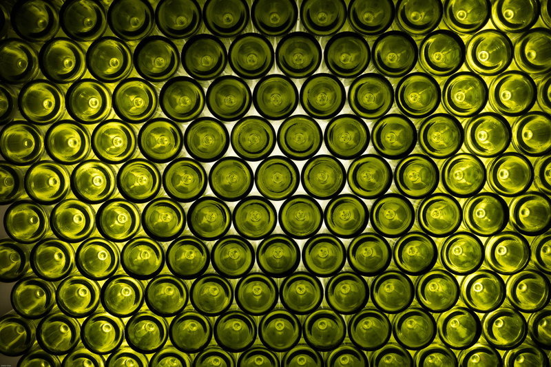 bottle, backgrounds, no people, order, abundance, green, bottles, shelf, repetition, shiny, side by side, pattern, close-up, stack, design, indoors, circle