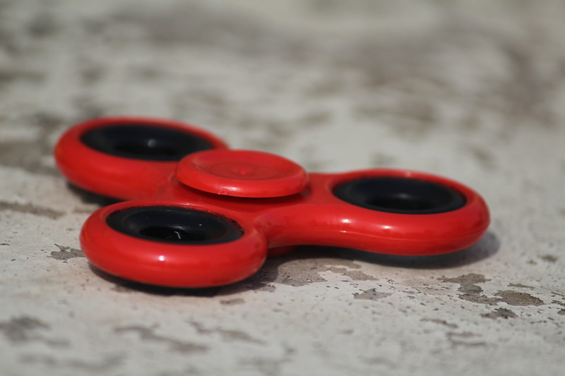 group of objects, sport, close-up, outdoors, single object, red, sand, plastic, focus on foreground, warning sign, selective focus, personal accessory