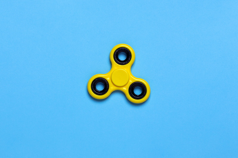 blades, gold colored, multi colored, cut out, high angle view, 4K, still life, spinner, blue background, toy, representation, copy space, indoors, blue