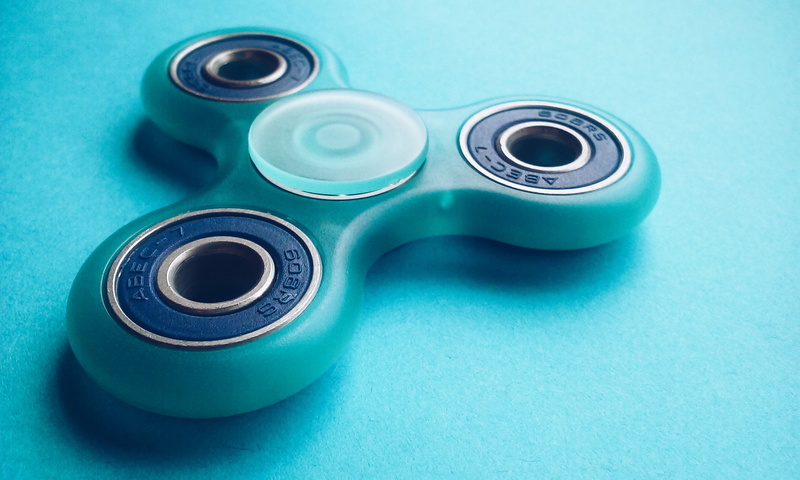 group of objects, round, game, close-up, food and drink, colored background, propeller, indoors, table, studio shot, turquoise, blue background, medium group of objects